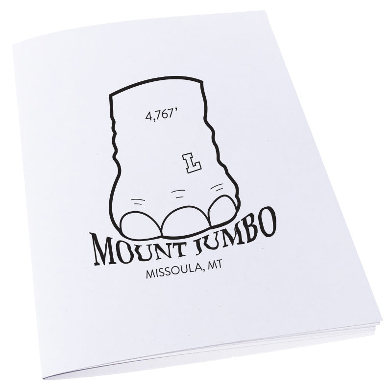 Elephant foot stomping on the words Mount Jumbo in Missoula, MT on a notebook.