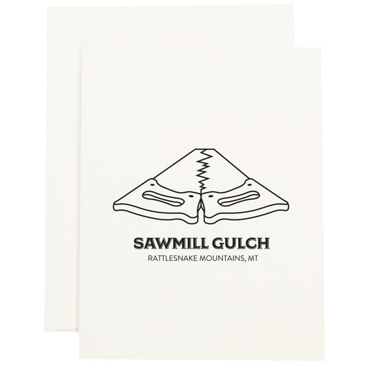 Image of two saws placed tooth-edge to tooth-edge to represent Sawmill Gulch in Missoula, MT on a greeting card.